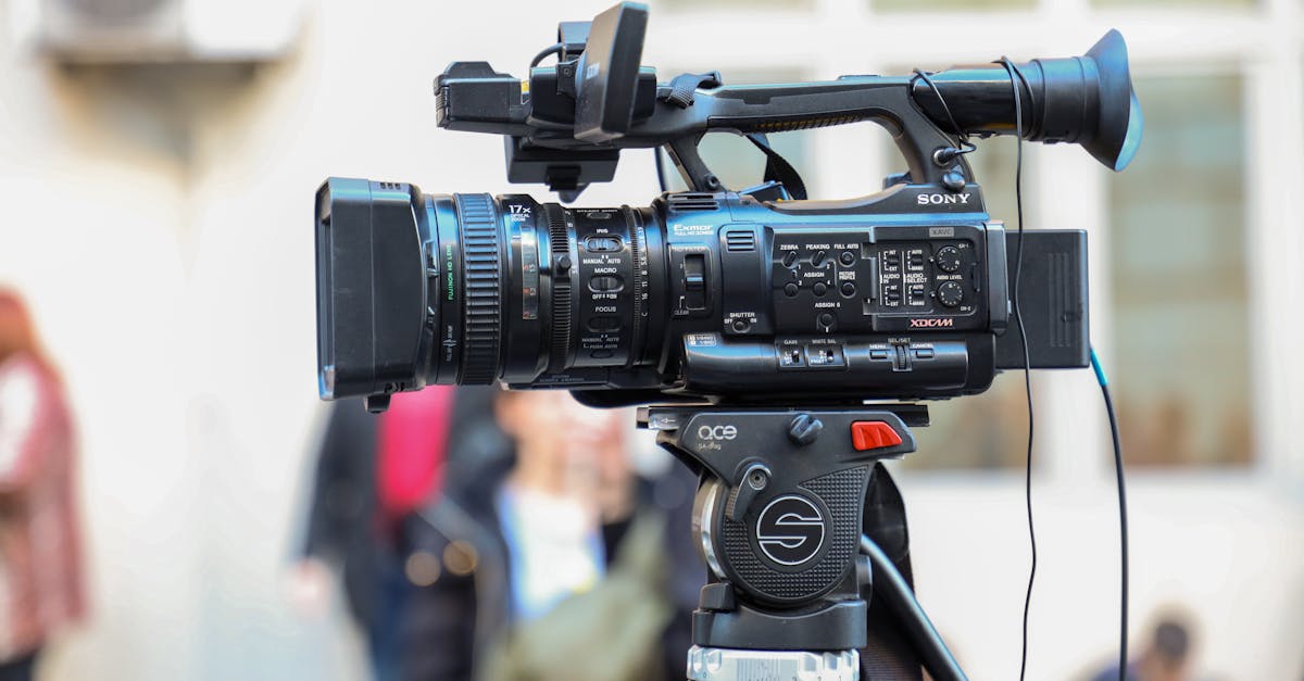 Close-up of a Sony video camera mounted on a tripod for outdoor filming.